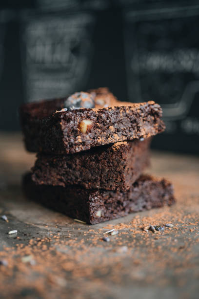 istock Chocolate brownie with blueberry on dark background 1355788647