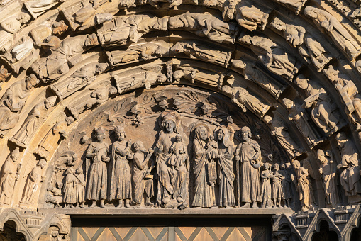Richly decorated gothic facade of the basilica with the sculptures holy persons