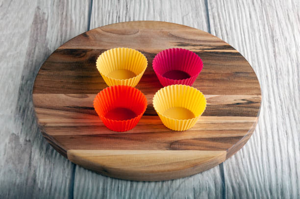 istock Four multicolored silicone molds stand on a wooden stand and a gray background 1355793371