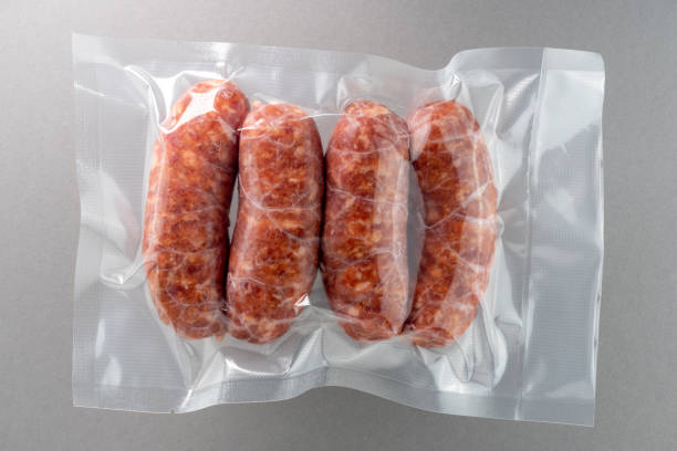Italian salamella sausage in vacuum packed Italian salamella sausage in vacuum packed sealed for sous vide cooking isolated on grey background in top view vacuum packed stock pictures, royalty-free photos & images