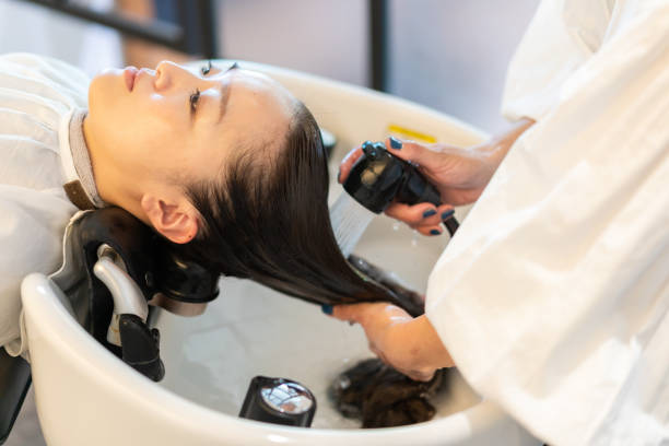 istock A hairdresser shampooing a customer 1355798524