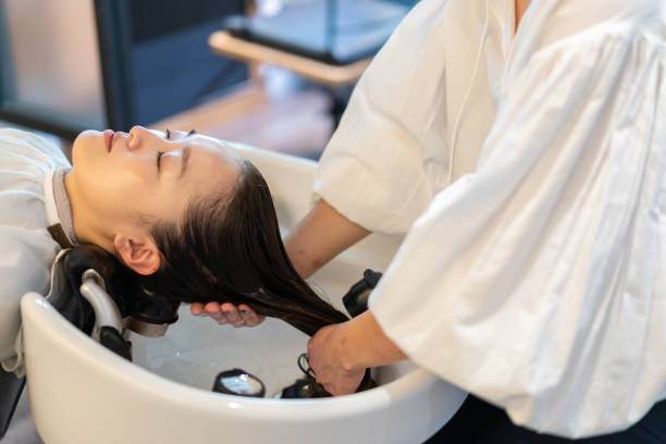 istock A hairdresser shampooing a customer 1355798528