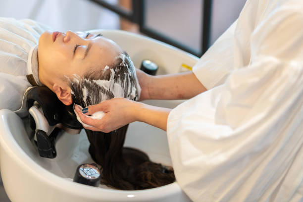 istock A hairdresser shampooing a customer 1355798535