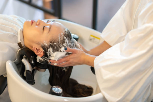 istock A hairdresser shampooing a customer 1355798539