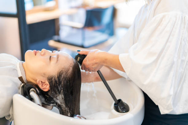 istock A hairdresser shampooing a customer 1355798540