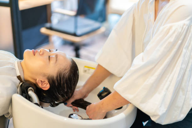 istock A hairdresser shampooing a customer 1355798541