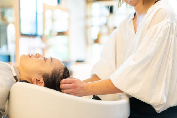 istock A hairdresser shampooing a customer 1355798545