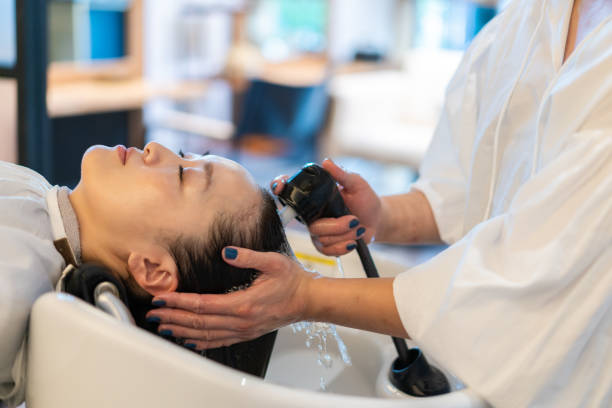 istock A hairdresser shampooing a customer 1355798556