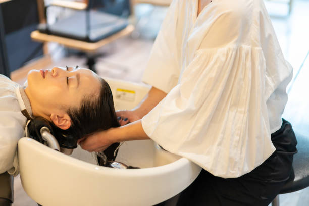 istock A hairdresser shampooing a customer 1355798557