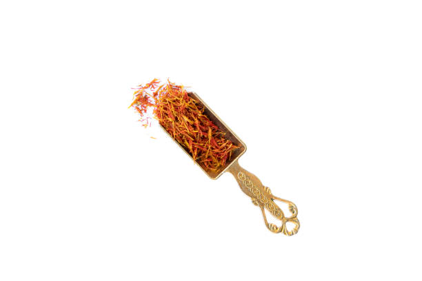 istock Saffron in metal shovel isolated on white background 1355798724