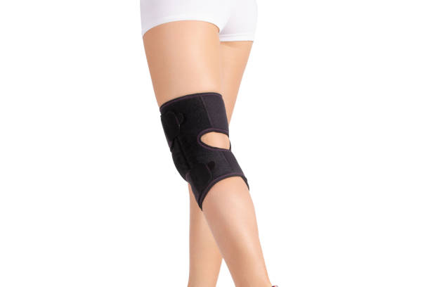 istock Knee Support Brace on leg isolated on white background. Orthopedic Anatomic. Braces for knee fixation, injuries and pain. Knee Joint Bandage Sleeve. Elastic Sports 1355800574