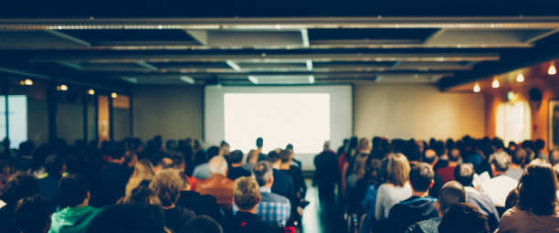 Business conference Business conference with unrecognizable audience. Shallow DOF, selective focus. lecture hall stock pictures, royalty-free photos & images