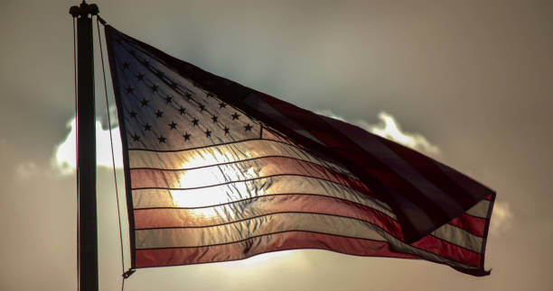 istock American flag covering the sun. 1355800782