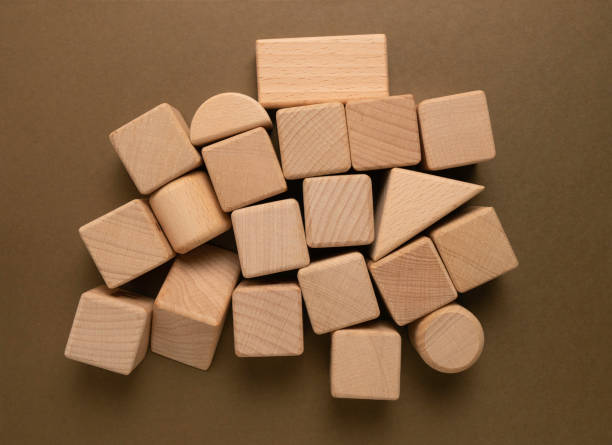 istock Wooden Geometric Shapes Cube on Paper 1355800822