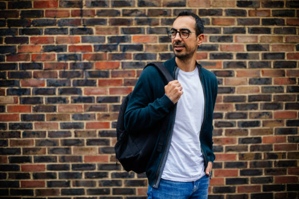 istock Young Man in urban city brick wall 1355801875