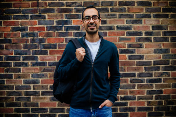 istock Young Man in urban city brick wall 1355801890
