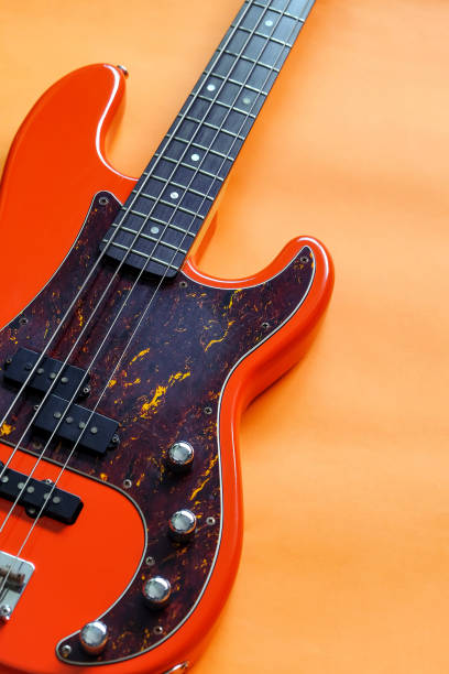 istock orange electric bass guitar 1355802767