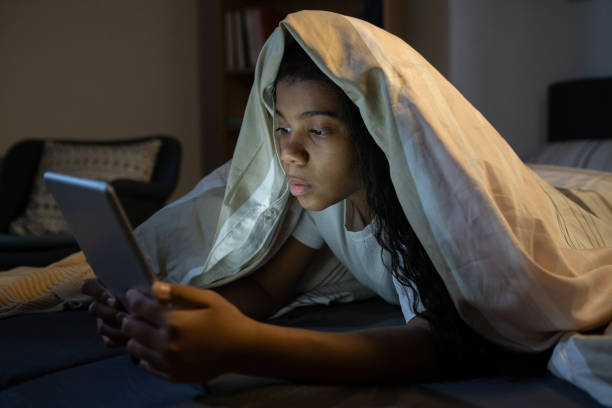 istock Girl Reading Internet News At Night 1355806444