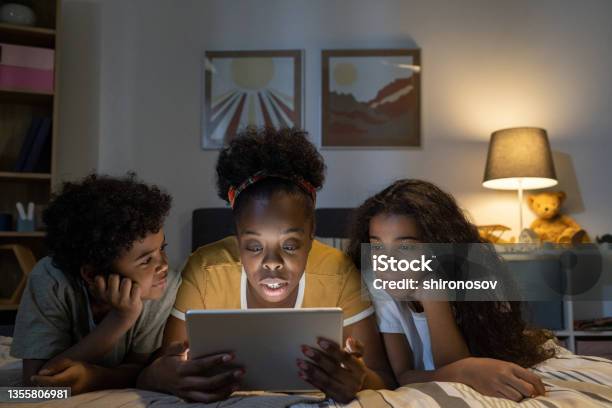 Blackwoman Reading Fairy Tale On Tablet To Kids Stock Photo - Download Image Now - 10-11 Years, 25-29 Years, 8-9 Years