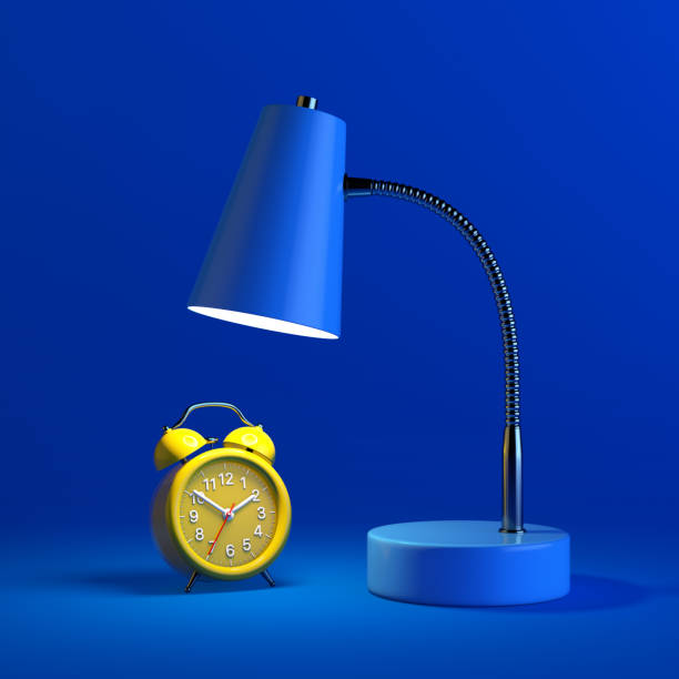 istock Yellow Alarm Clock Under Blue Modern Desk Lamp. 3d Rendering 1355807367