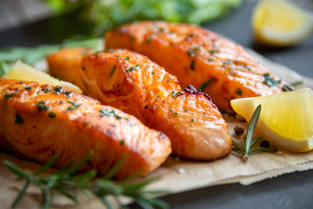 istock Cooked salmon fish fillet with lemon and rosemary 1355807488