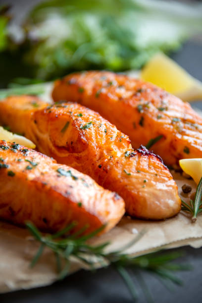 istock Cooked salmon fish fillet with lemon and rosemary 1355807535