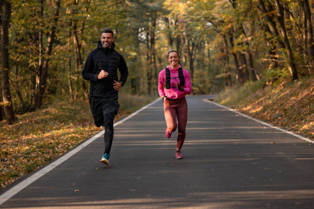 istock Happy Caucasian couple doing their daily training routine in nature 1355810691