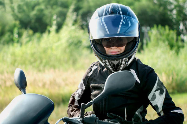 istock An elderly woman on a motorcycle wearing special protective clothing. Active maturity. 1355810711