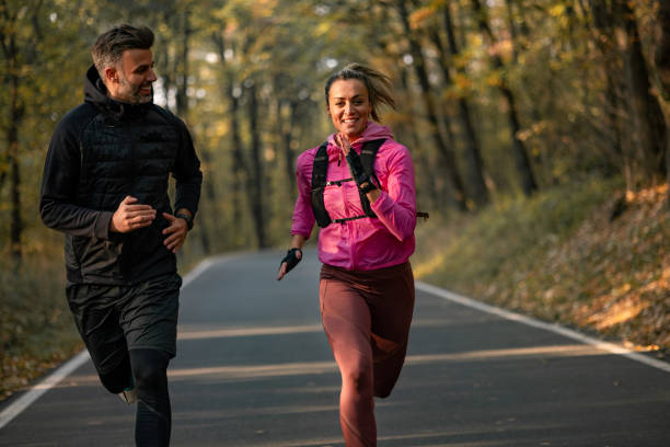 istock Happy Caucasian couple doing their daily training routine in nature 1355810717