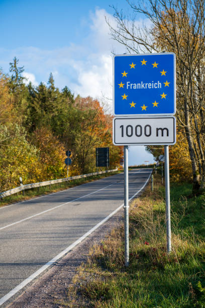 istock Sign indicating the French border in German 1355810724