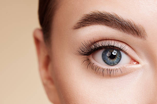 istock Female eye with long false eyelashes 1355811964