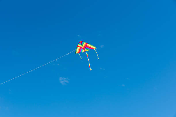 istock Colorful Kites flying over the sky 1355812829