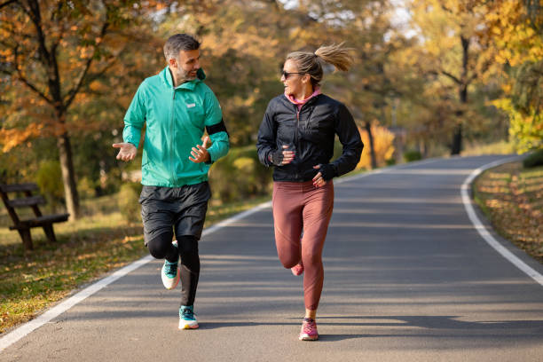 istock Happy Caucasian couple doing their daily training routine in nature 1355812864