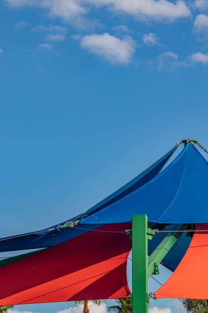 istock Canvas shade sails against a bright blue sky 1355813935