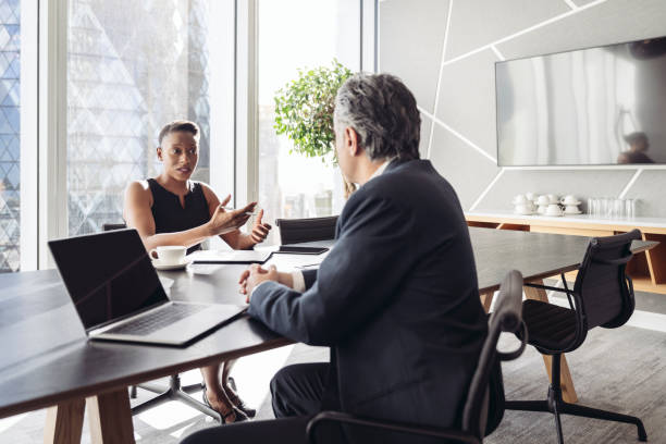 British investment managers conversing in board room