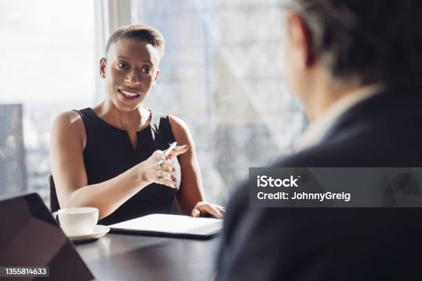 Confident Black Businesswoman Talking With Male Colleague Stock Photo - Download Image Now