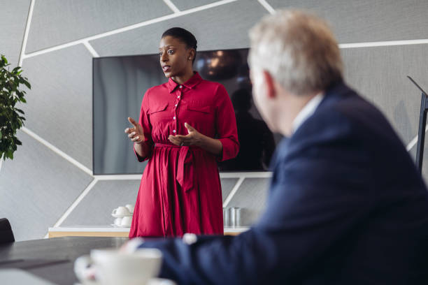 Mid adult businesswoman presenting ideas to investment team