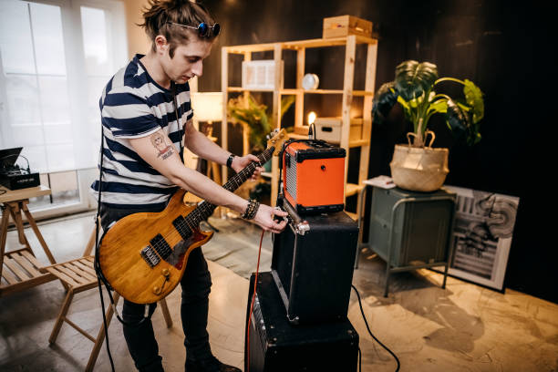 Young man playing guitar at home