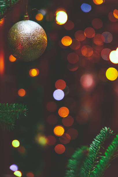 istock Christmas tree with ball toy on branches vertical soft focus picture with blurred festive atmosphere lights backgrounds 1355816829