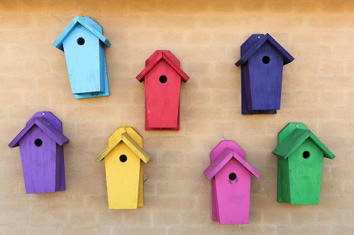 Colorful nesting boxes on a wall