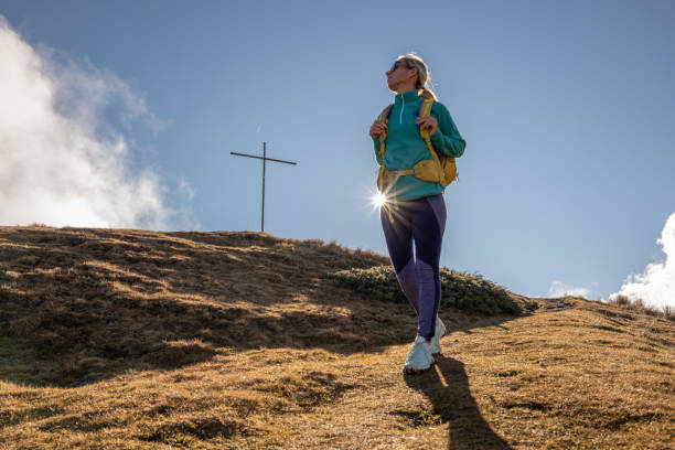 istock Woman hiking on mountain trail 1355819220