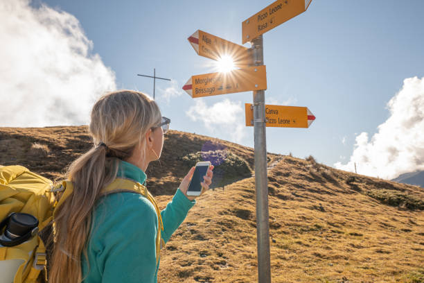 istock Woman hiking on mountain ridge, clouds 1355819265