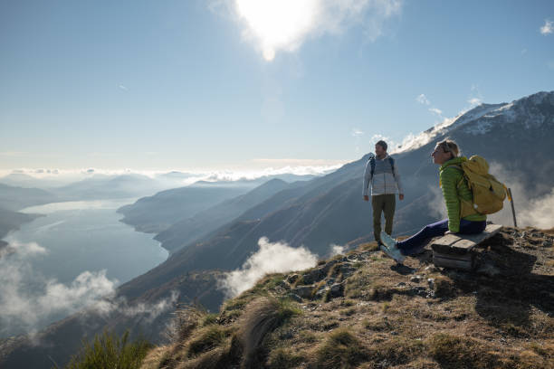 istock Young couple hiking contemplating view 1355820242