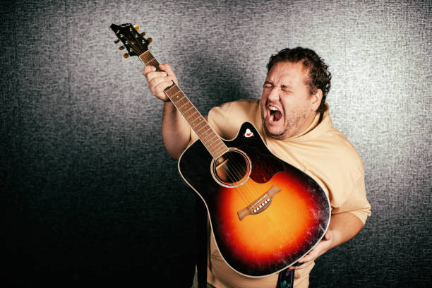 istock Funny man plays the guitar. 1355820598
