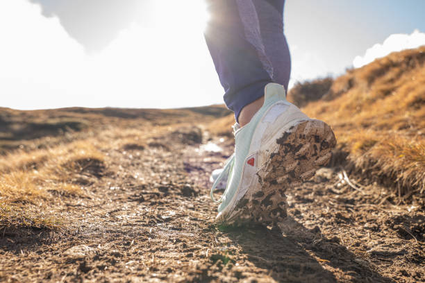Close up on woman's shoes wile she hikes on mountain terrain