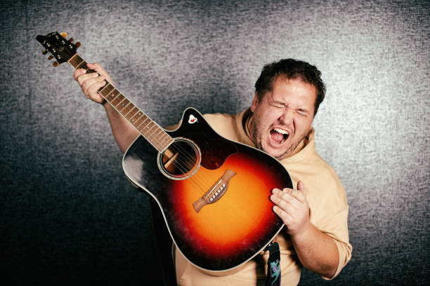 istock Funny man plays the guitar. 1355821782