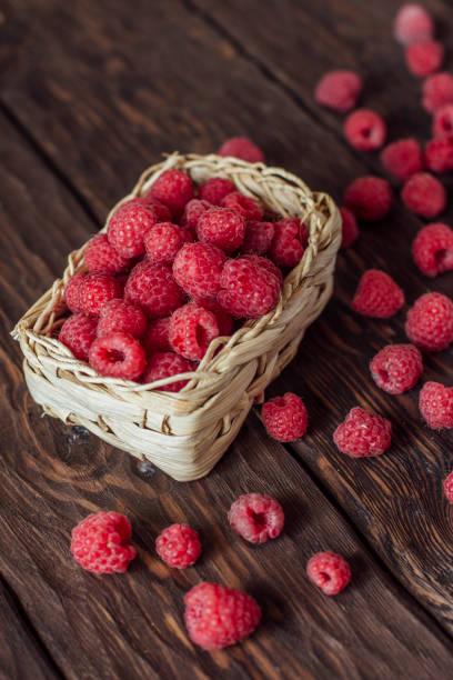 istock fresh raspberries on a wooden background 1355821794