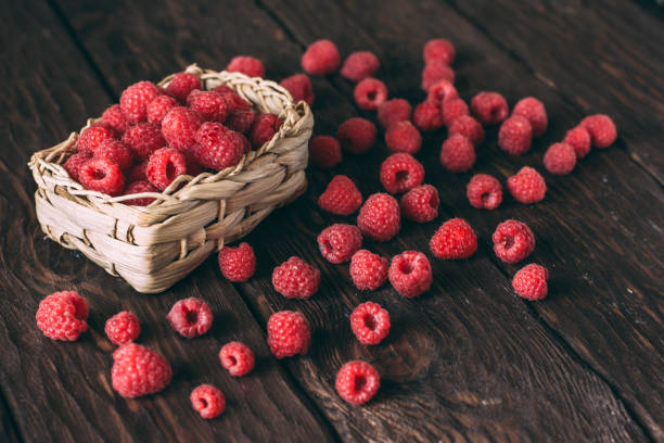 istock fresh raspberries on a wooden background 1355821795