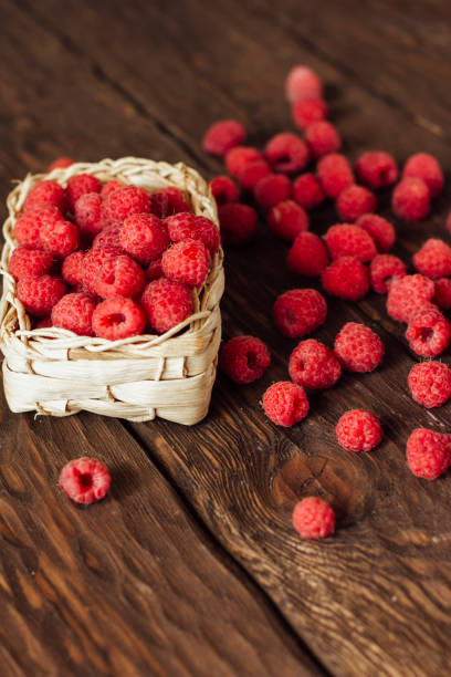 istock fresh raspberries on a wooden background 1355821807