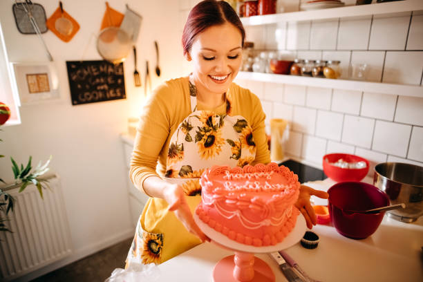 istock Pretty women holding a cake 1355825303